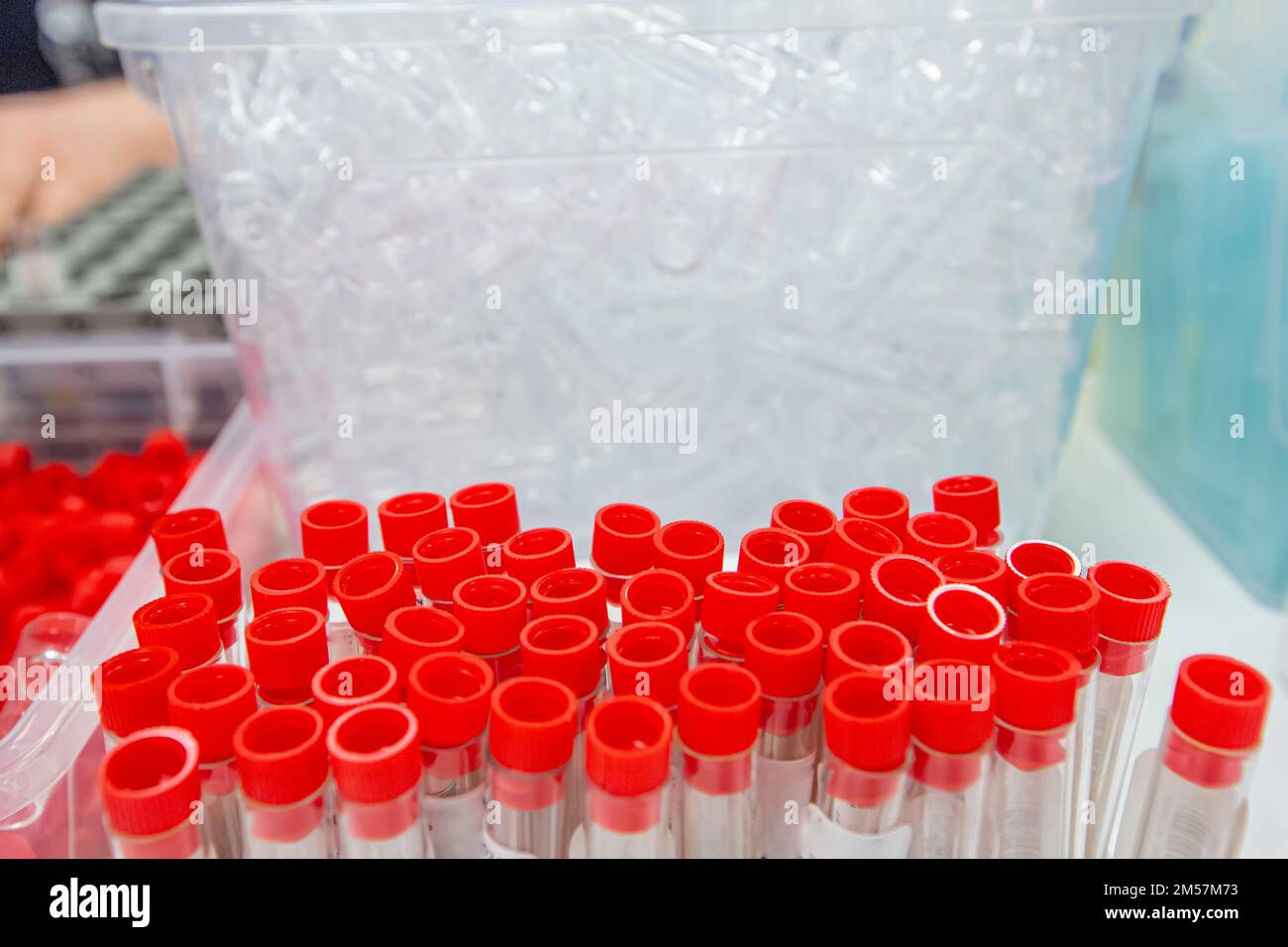 Blood sample tube from a shelf with analysis machines in the laboratory