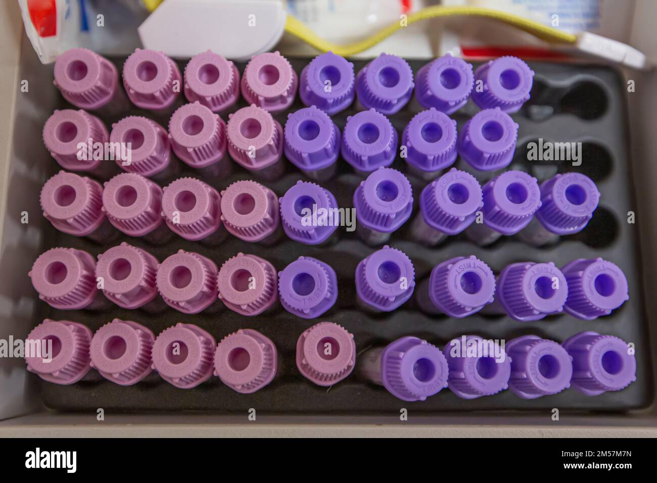 Blood sample tube from a shelf with analysis machines in the laboratory
