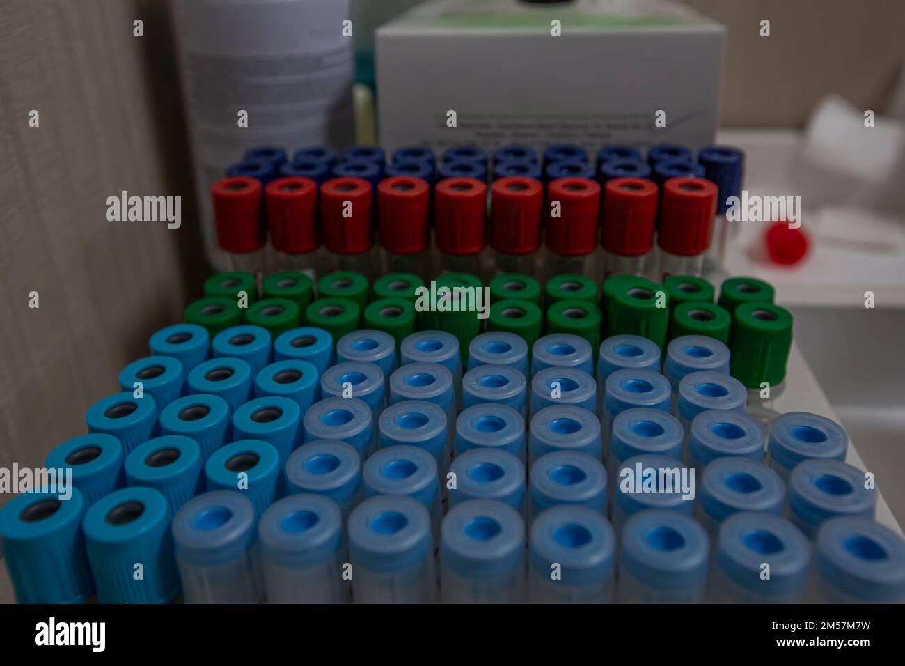 Blood sample tube from a shelf with analysis machines in the laboratory
