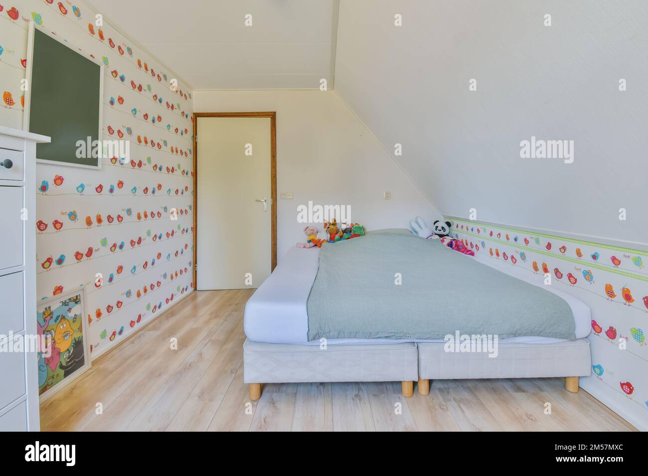 a child's bedroom with colorful wallpapers on the walls and white