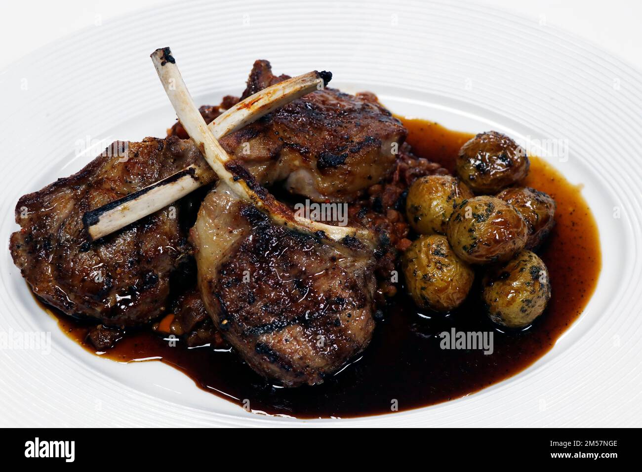 spice marinated grilled lamb chops or rack with baby potatoes and roast