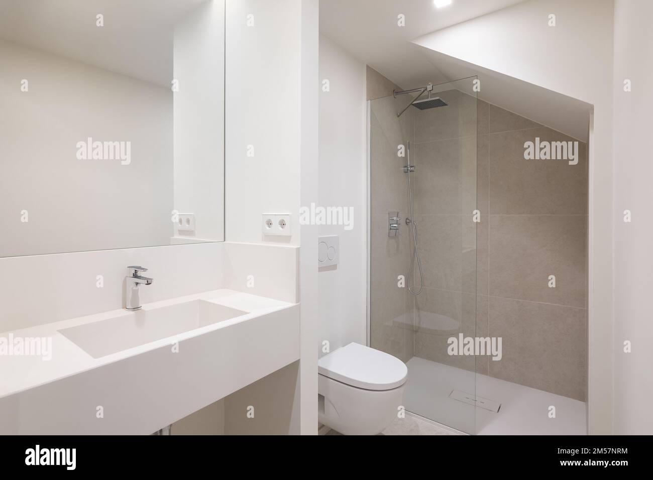 Bright bathroom with toilet and shower. Sanitary ware made of high