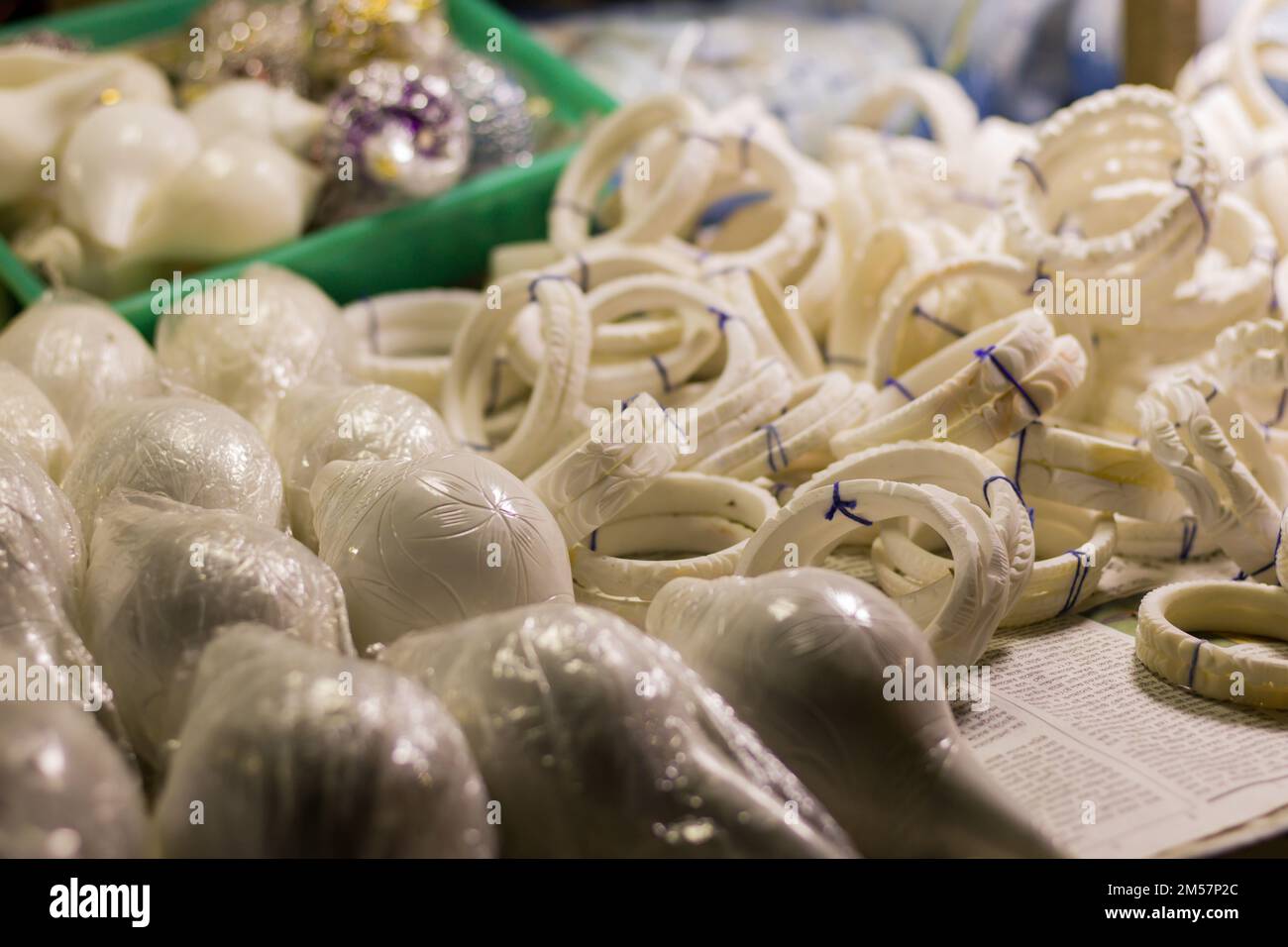 shankha or white bangles made of conch shells being sold near sea beach of digha. These bangles are traditional attire for married bengali women. Stock Photo