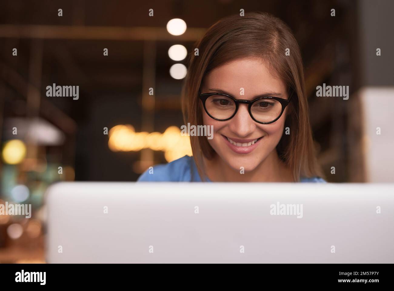 Working on her blog. an attractive young woman blogging in her local coffee shop. Stock Photo
