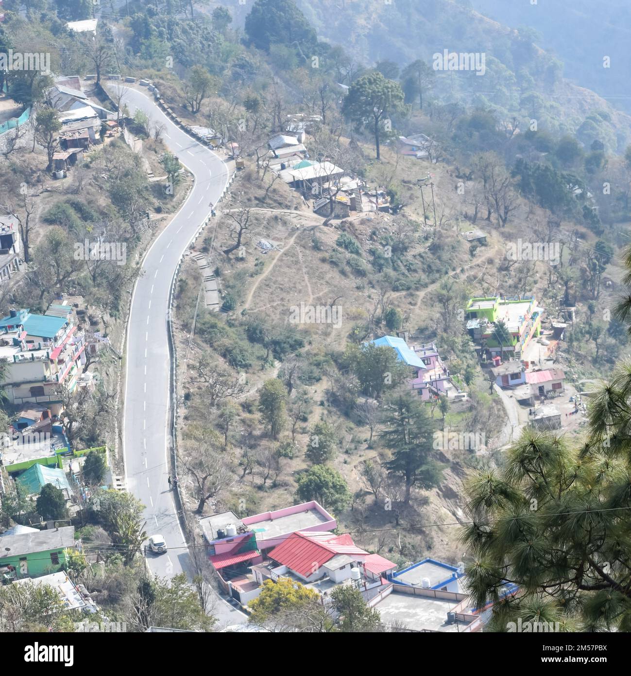 Aerial top view of traffic vehicles driving at mountains roads at Nainital, Uttarakhand, India, View from the top side of mountain for movement of tra Stock Photo