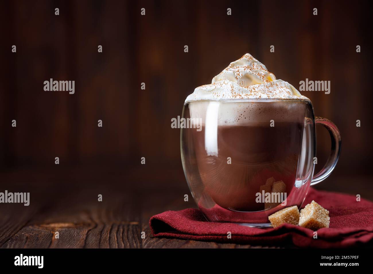 cocoa or hot chocolate with whipped cream in glass cup on table Stock Photo