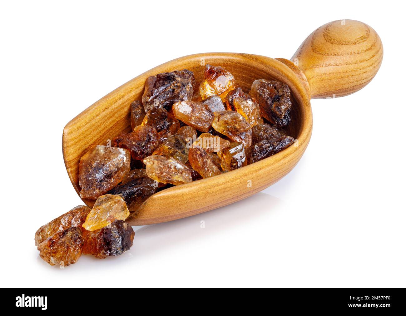 brown caramelized sugar in wooden scoop isolated on white Stock Photo