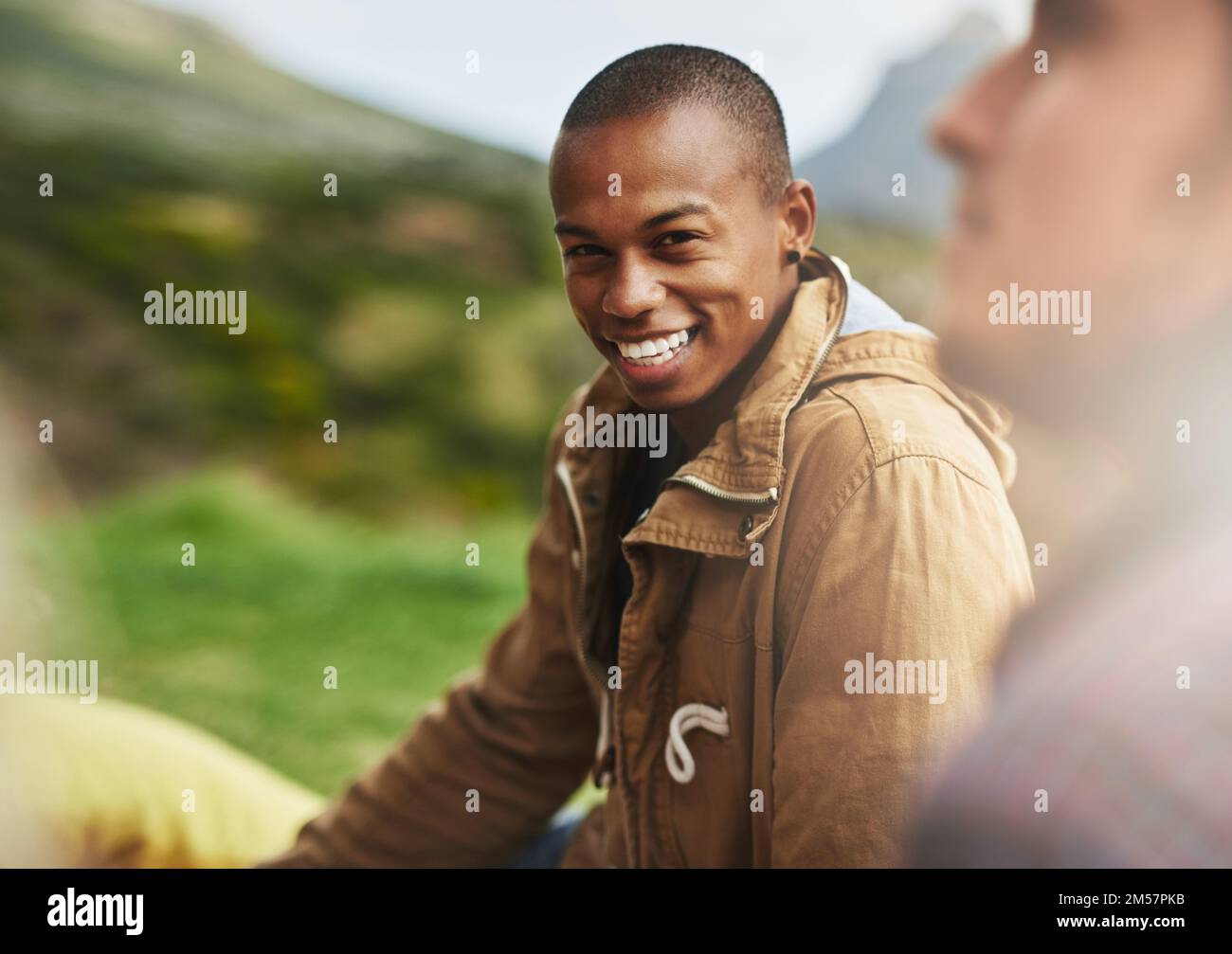 In a laid-back state of mind. Portrait of a happy young man hanging out with his friends outside. Stock Photo