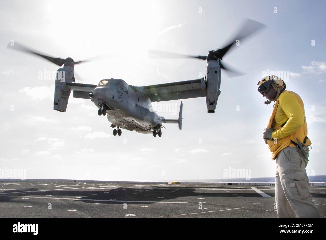 PACIFIC OCEAN (Dec. 4, 2022) – An MV-22 Osprey assigned to Marine Medium Tiltrotor Squadron (VMM) 362 approaches the flight deck of amphibious transport dock USS Anchorage (LPD 23) during flight operations, Dec. 4, 2022. The ability to operate seamlessly and simultaneously on the sea, ashore, and in the air represents the unique value of amphibious capability provided by the Amphibious Ready Group and Marine Expeditionary Team. The Makin Island Amphibious Ready Group, comprised of amphibious assault ship USS Makin Island (LHD 8) and amphibious transport docks USS Anchorage (LPD 23) and USS Joh Stock Photo
