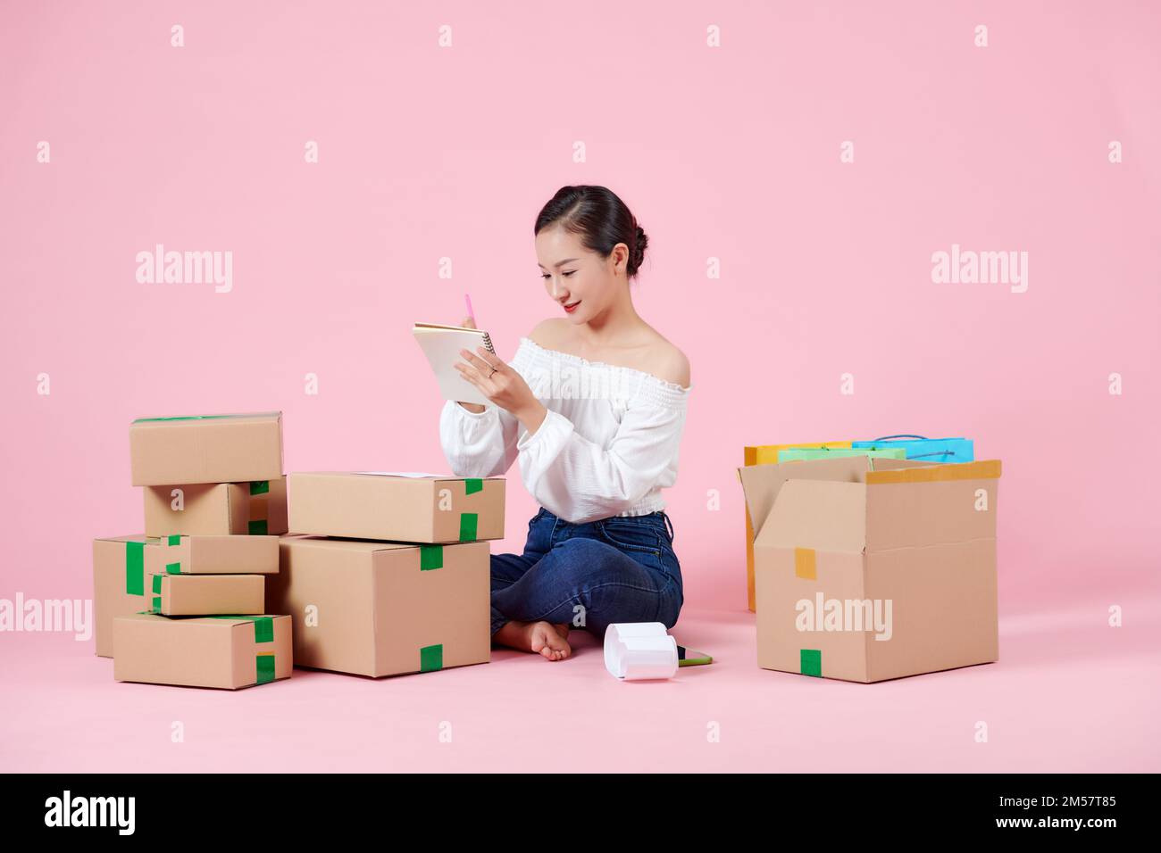 Young beautiful asian woman prepare to send products by orders to her costomers Stock Photo
