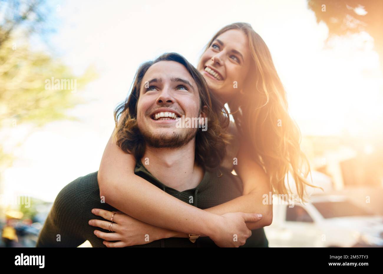 Couple playing piggyback ride in park Stock Photo - Alamy