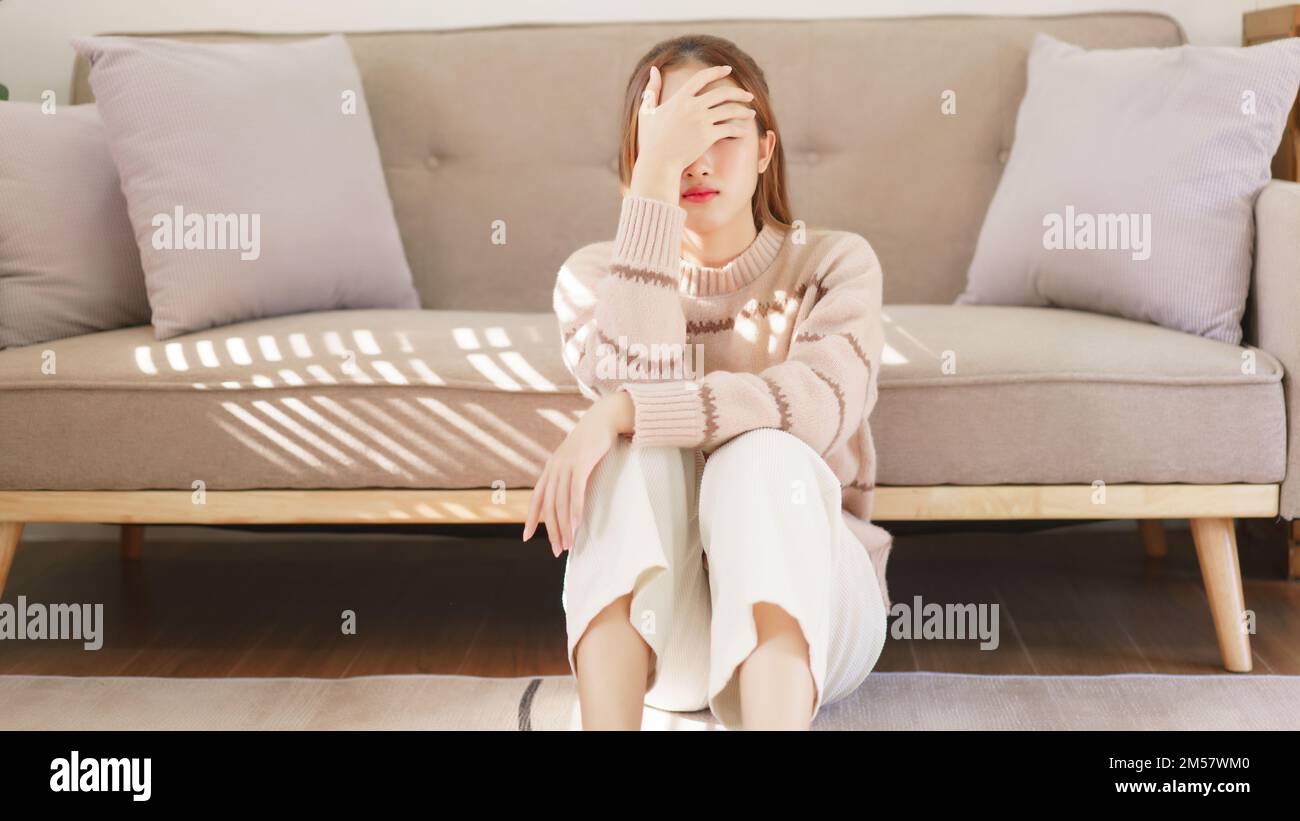 Rest time concept, Women is sitting on the floor and touch aching ...