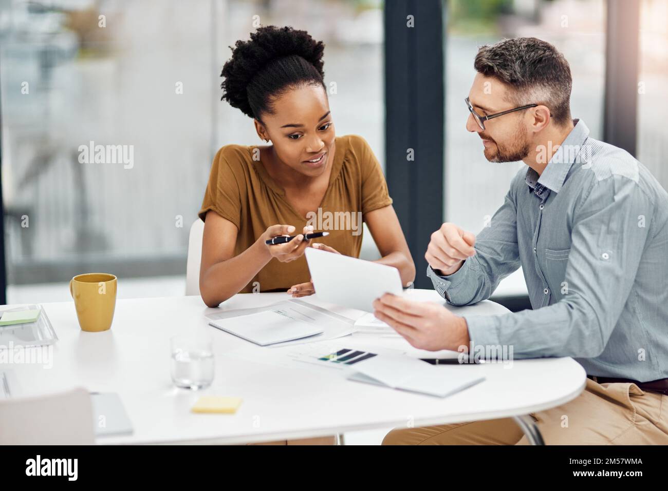 Theyre a winning team. two businesspeople working together in their office. Stock Photo