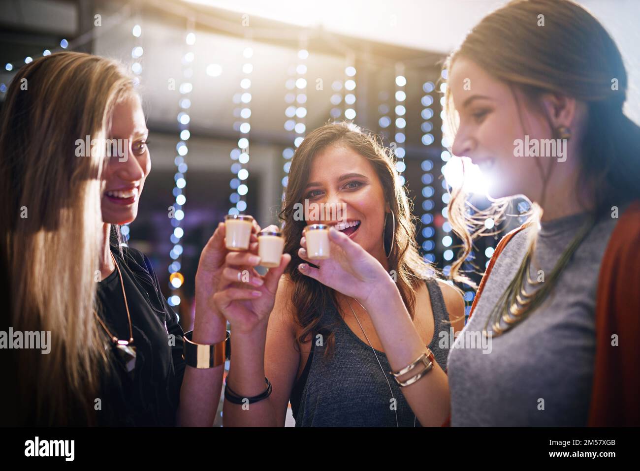 The party is in full swing now. a group of friends having shots together at a party. Stock Photo