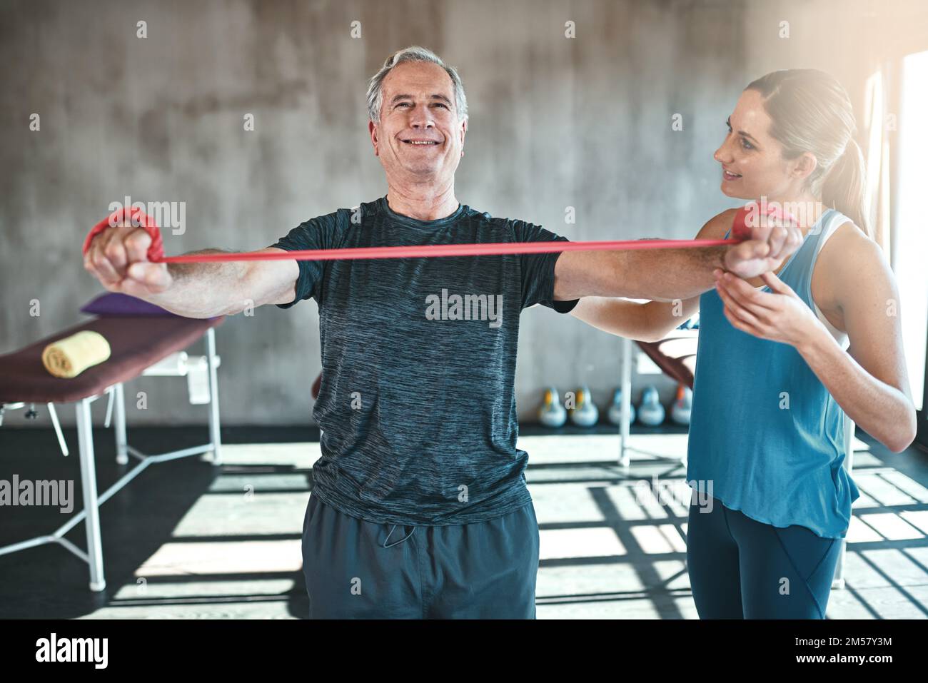 Improving range of motion with a resistance band workout. a senior man