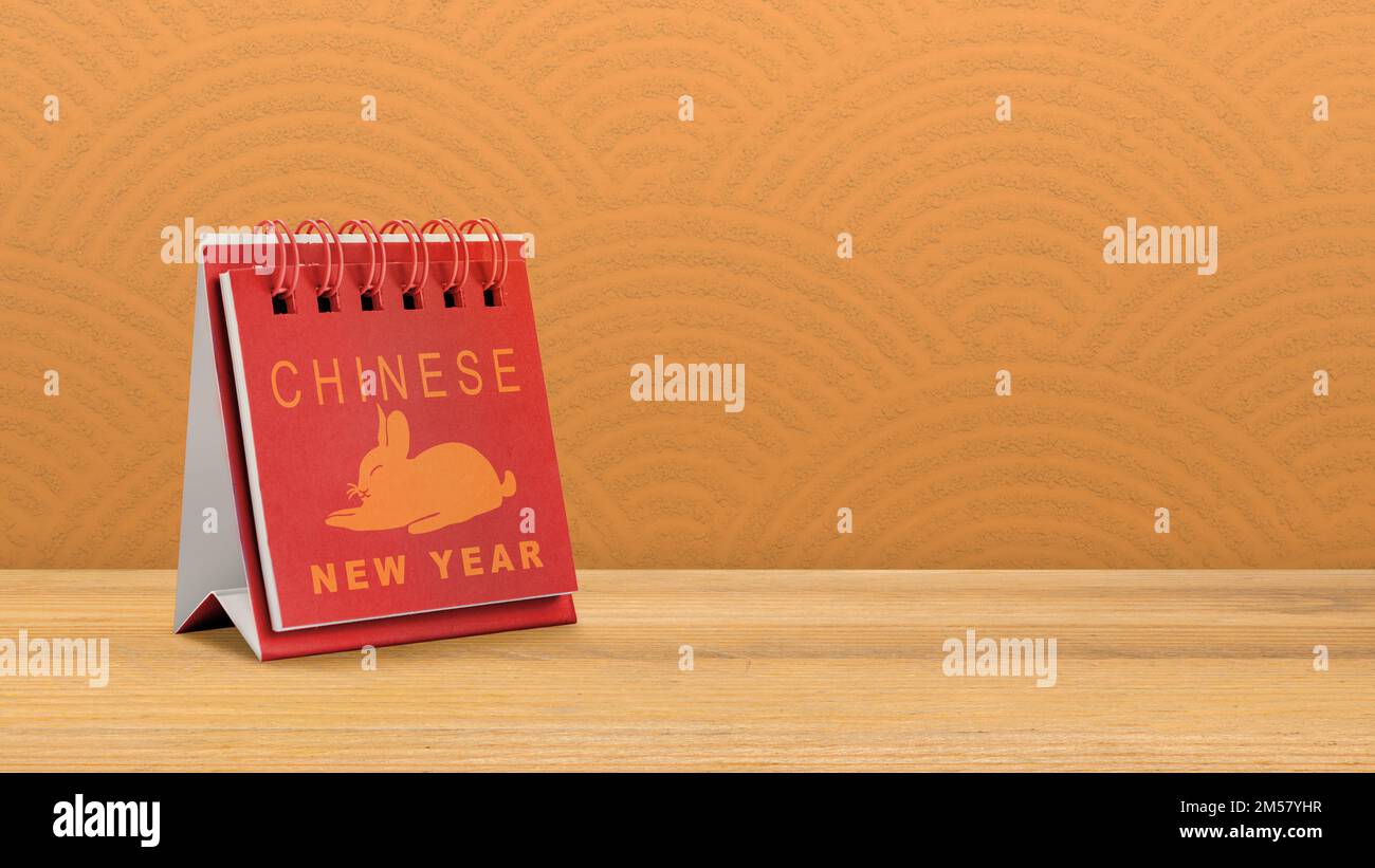 Calendar with Chinese New Year text with rabbit symbol on the table Calendar with Chinese New Year text with rabbit symbol on the table