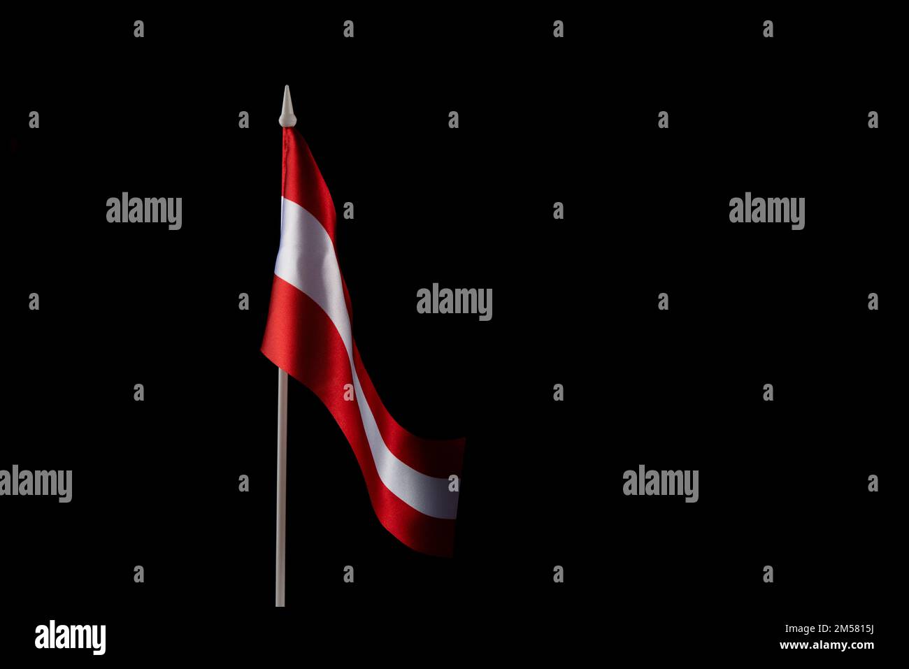 Small national flag of the Latvia on a black background Stock Photo