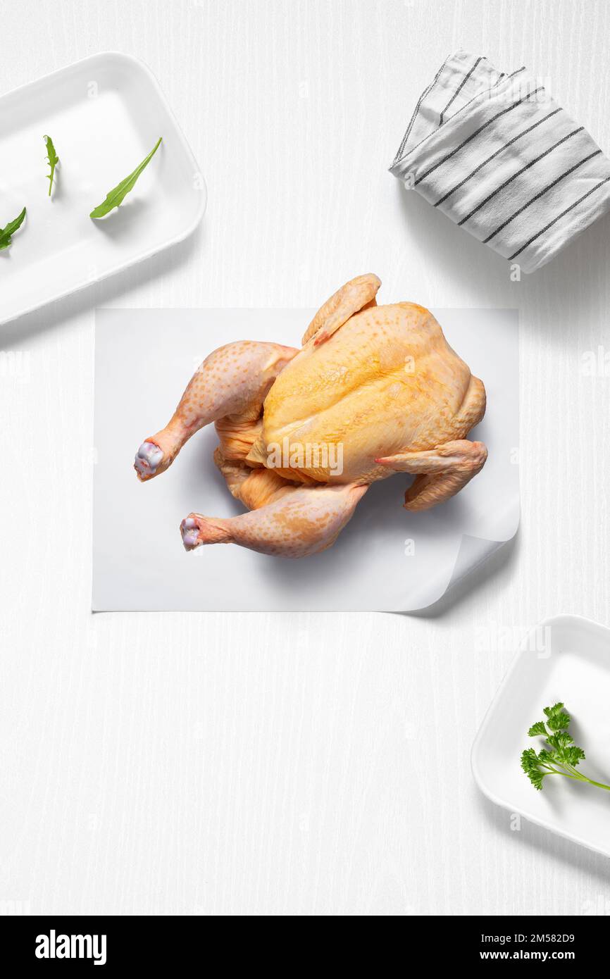 https://c8.alamy.com/comp/2M582D9/whole-chicken-on-a-kitchen-with-some-herbs-from-above-2M582D9.jpg