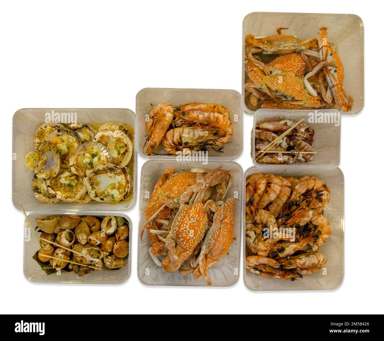 Die cut of seafood as crab and grilled shrimp in plastic box, on white