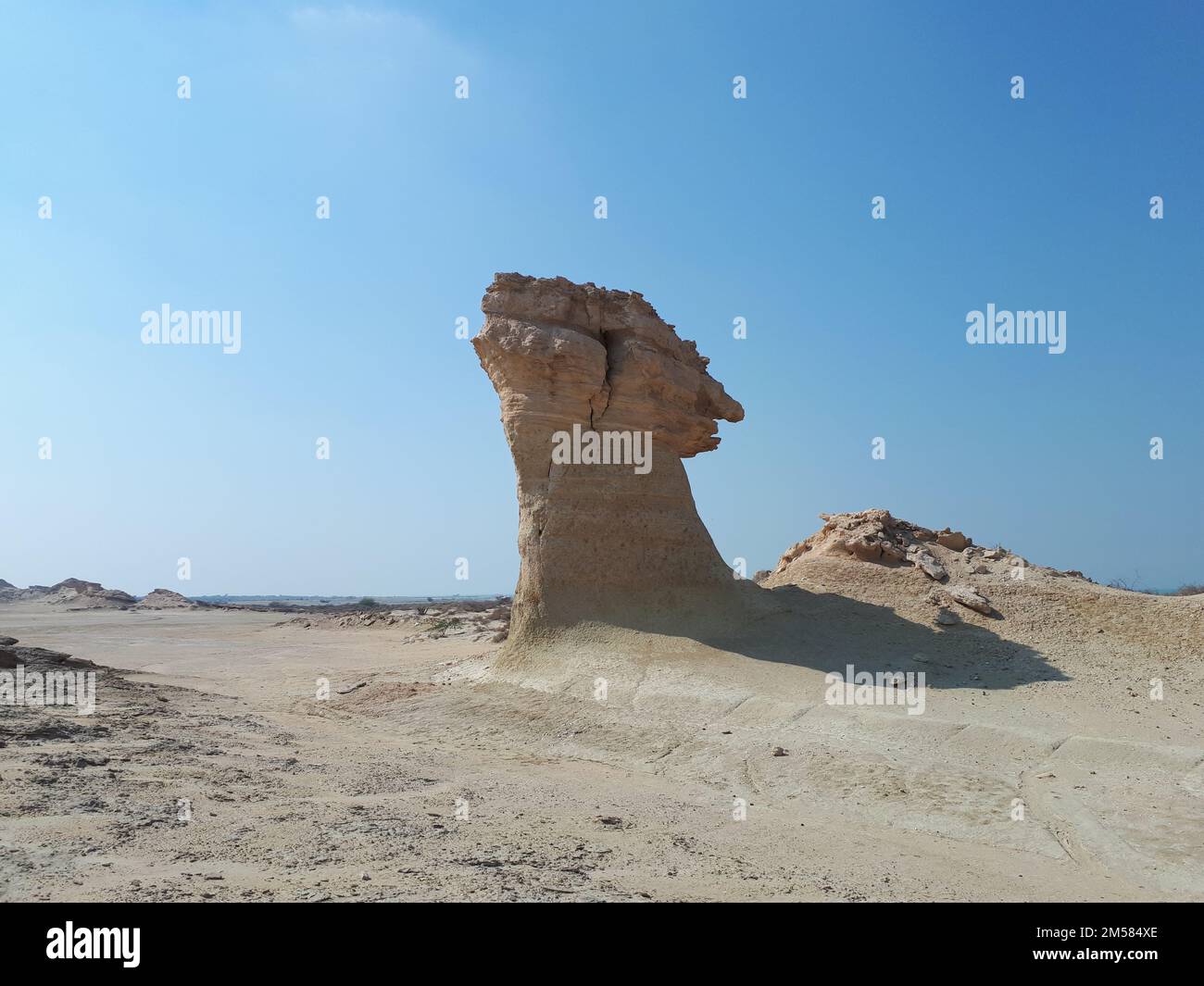 A rock formation in the desert on blue sky background Stock Photo - Alamy