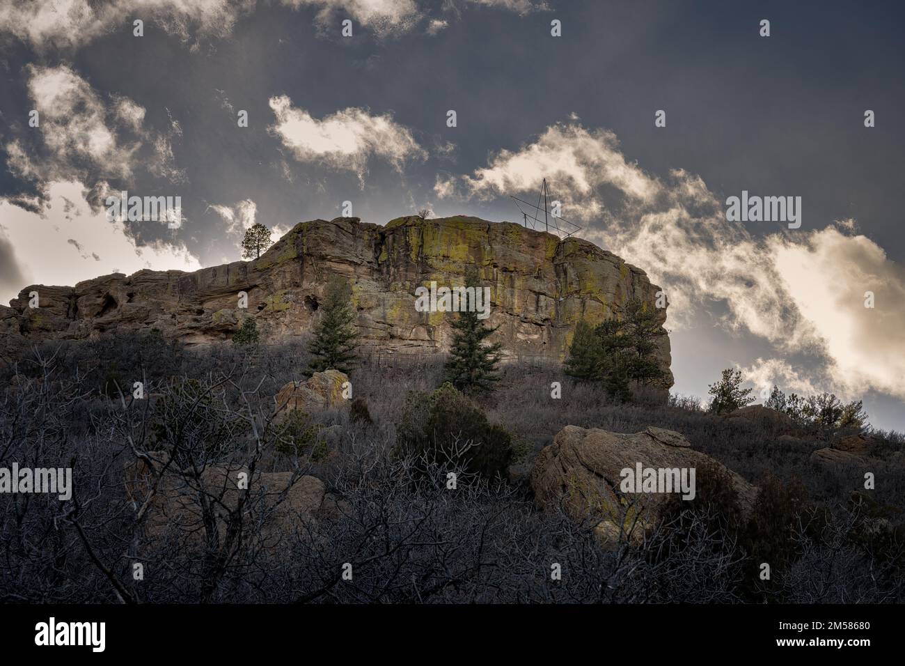 Angled Rocks Colorado A low angle of a rock formation on a hilltop surrounded by firs and ...