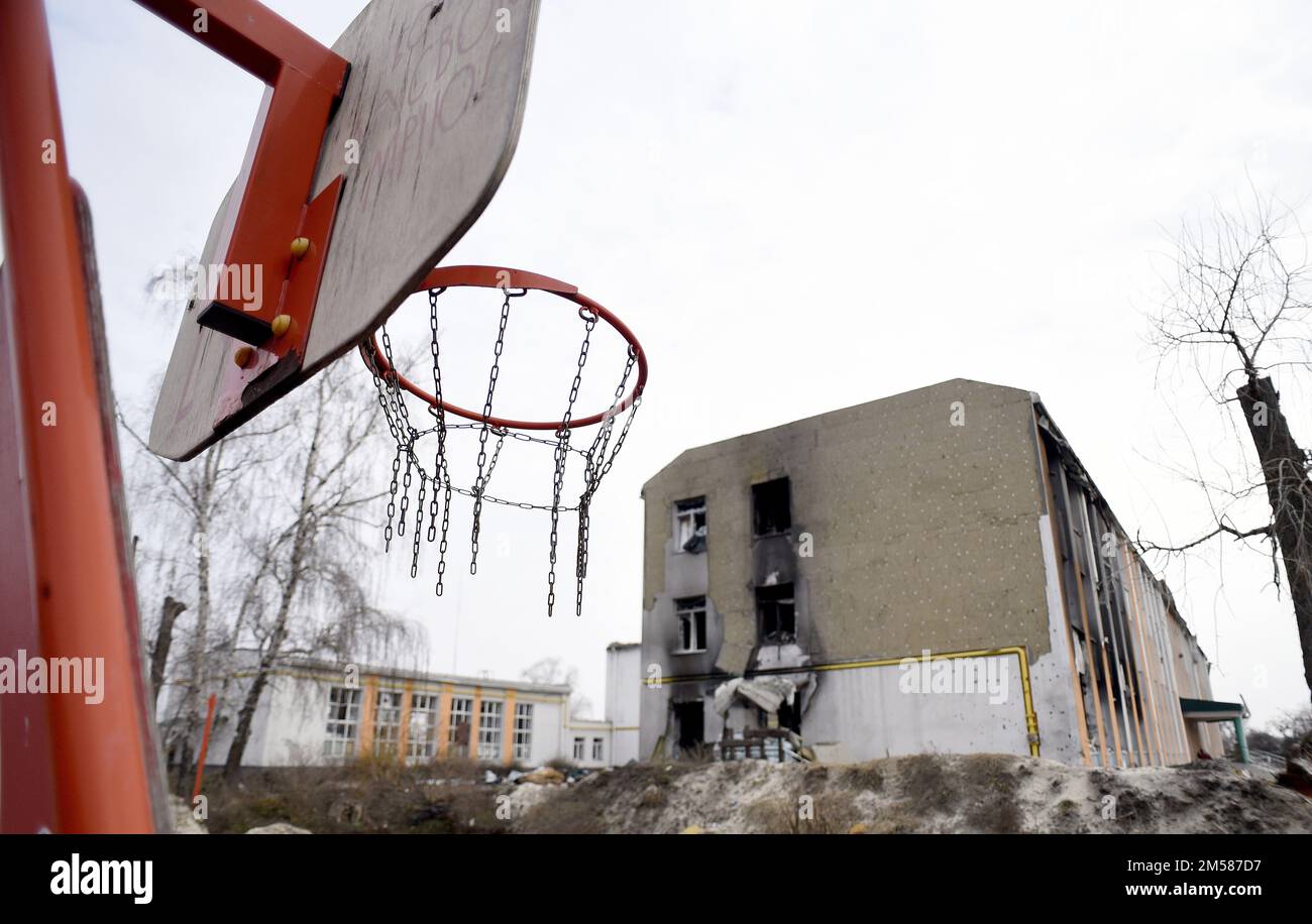Non Exclusive: IZIUM, UKRAINE - DECEMBER 25, 2022 - A basketball hoop is seen near the buildings of a school destroyed in the shelling of Russian troo Stock Photo