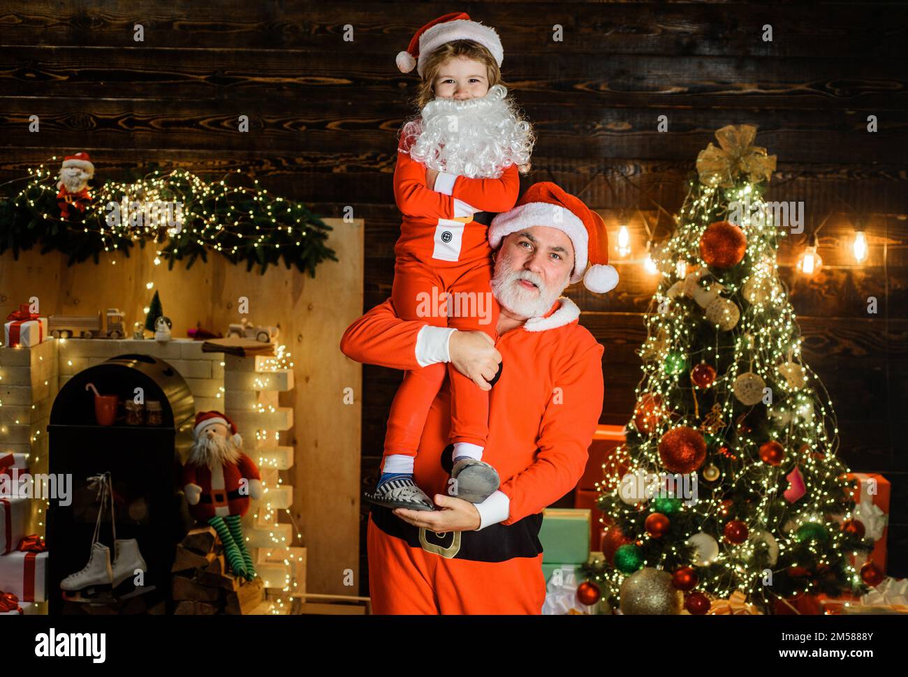 Merry Christmas and happy New Year. Santa Claus with little helper. Winter holidays. Stock Photo