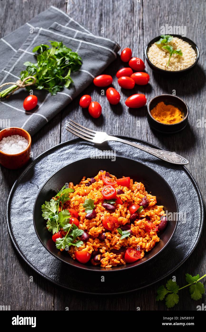 jollof-rice-with-red-beans-tomato-and-fresh-coriander-in-black-bowl-on