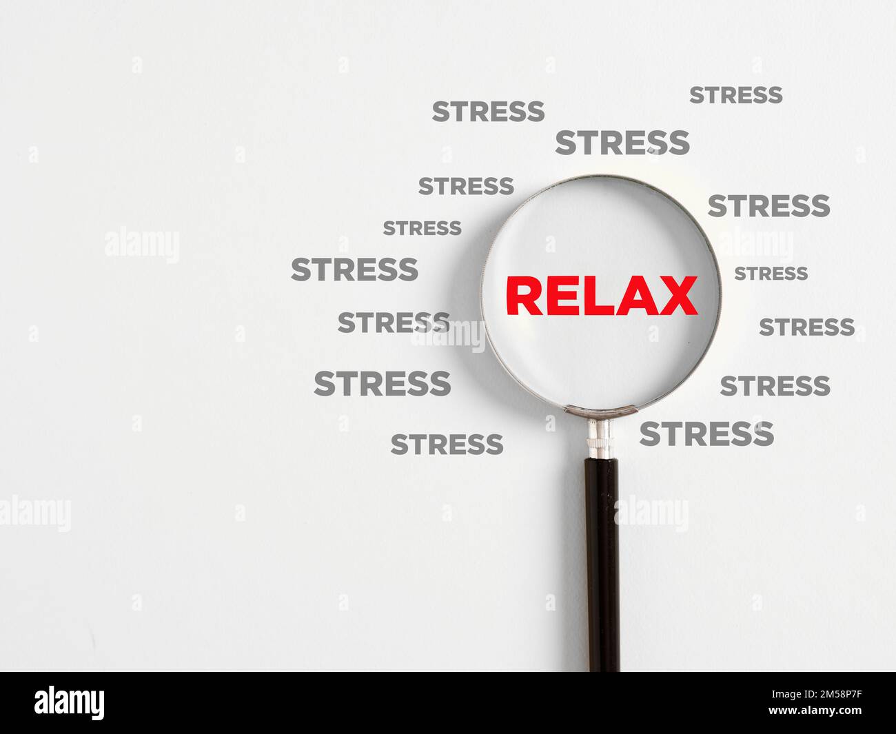 Magnifying glass magnifies the word relax surrounded with the opposite