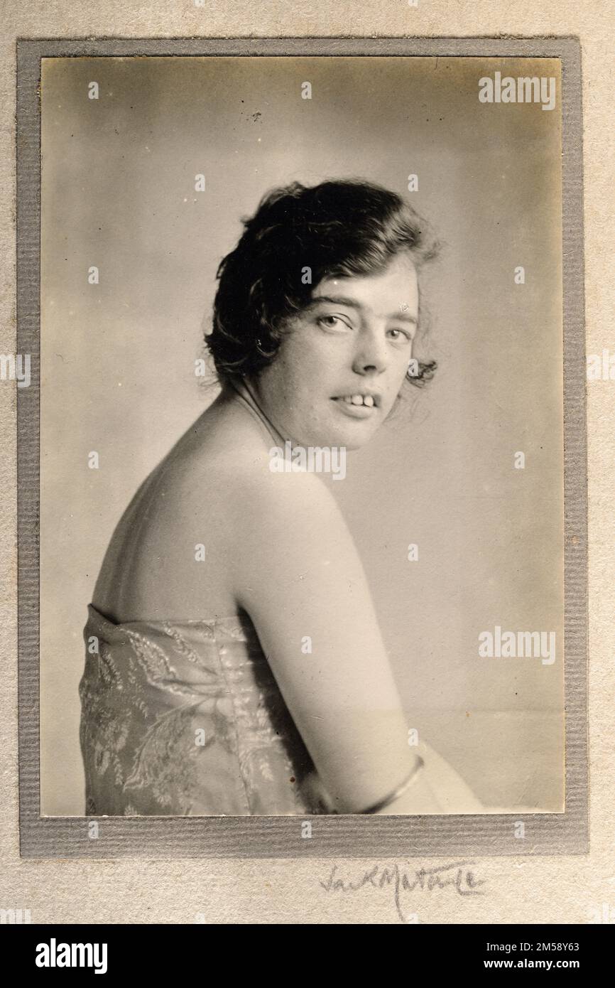 Vintage photograph of a young woman, off shoulder dress, arm bangle, hair back, 1920s, unknown Stock Photo