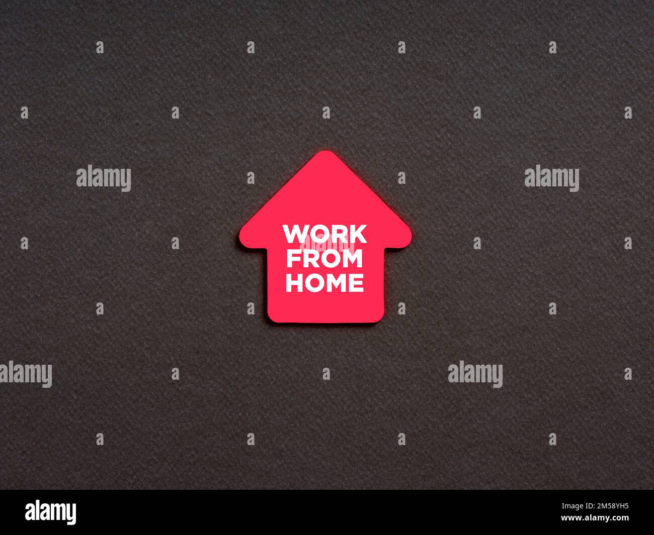 The message work from home written on a house shaped note paper. Freelance working from home concept. Stock Photo