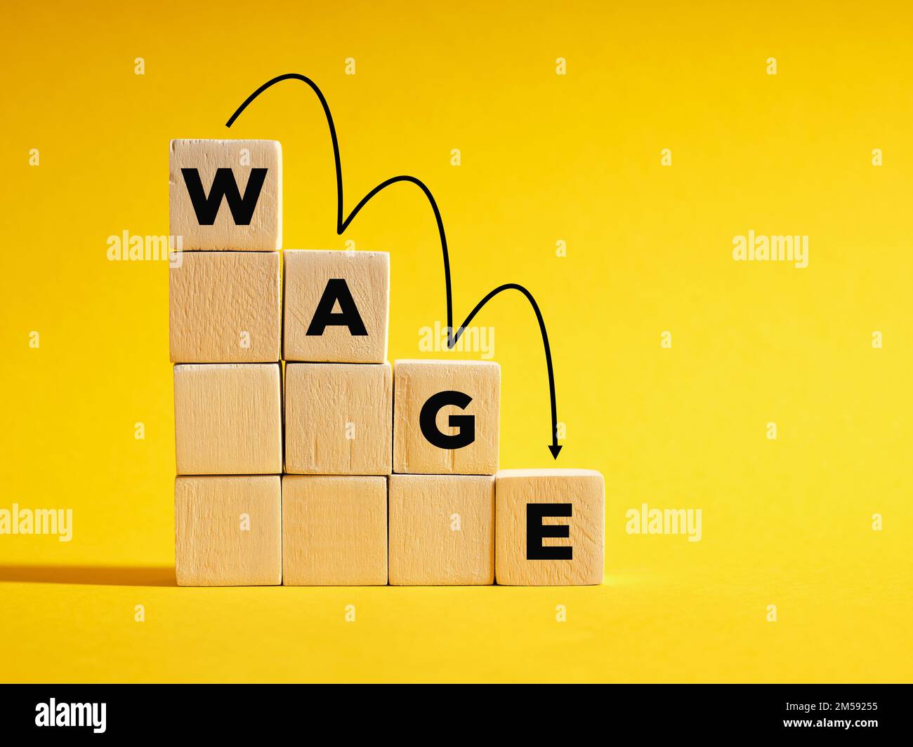 Declining wages and income drop. Economic crisis, recession, and poverty concept. The word Wage on descending step stairs of wooden cubes. Stock Photo