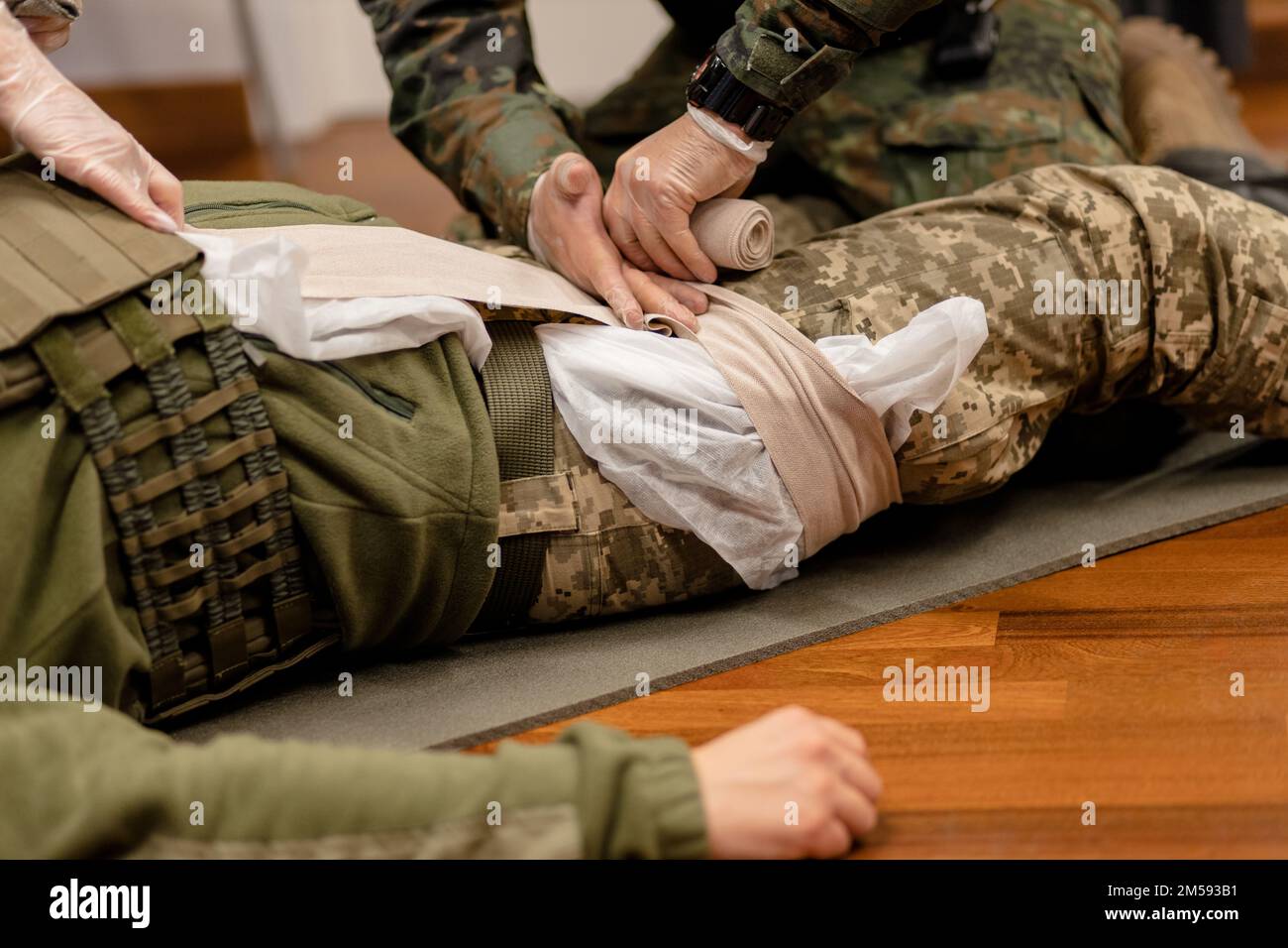 Training dressing of the wounded leg of a Ukrainian fighter, close-up. Stock Photo