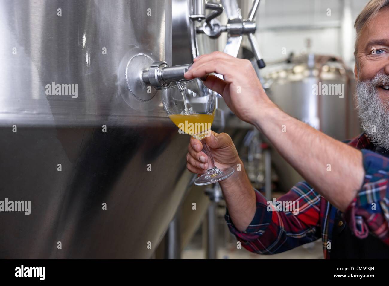 Brewery worker pouring fresh beer into the glass Stock Photo Alamy