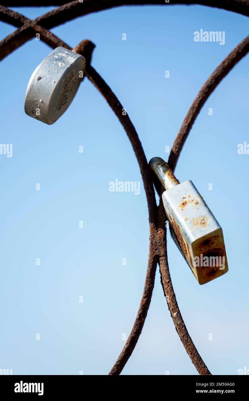 Padlocks attached to an old rusty iron door Stock Photo