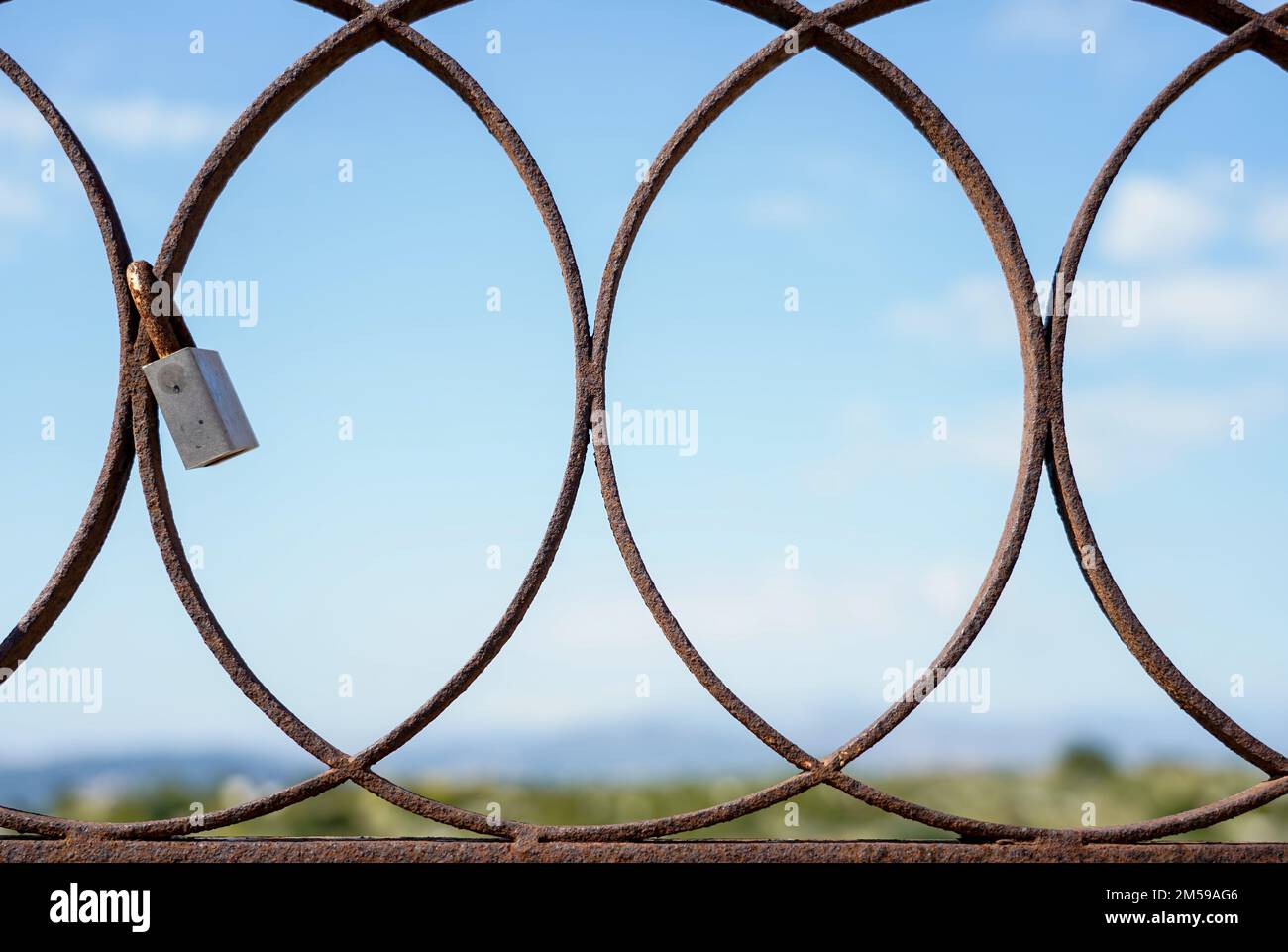 Padlocks attached to an old rusty iron door Stock Photo