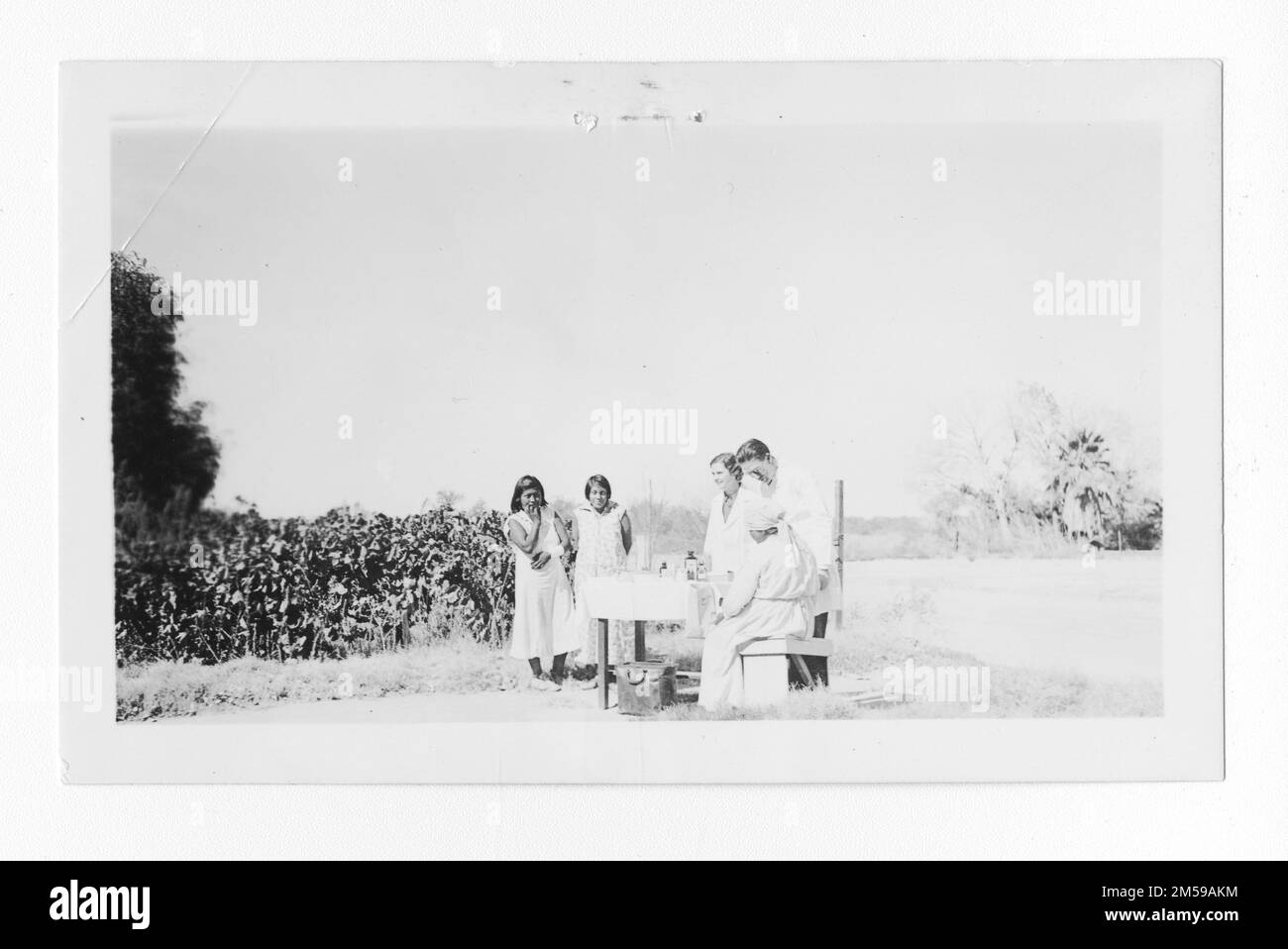 Original caption: 'A reluctant patient (Nurse Mabel Cowser and Dr. Gray)'. 1936 - 1942. Pacific Region (Riverside, CA). Photographic Print. Department of the Interior. Office of Indian Affairs. Mission Agency. 11/15/1920-6/17/1946. Photographs Stock Photo