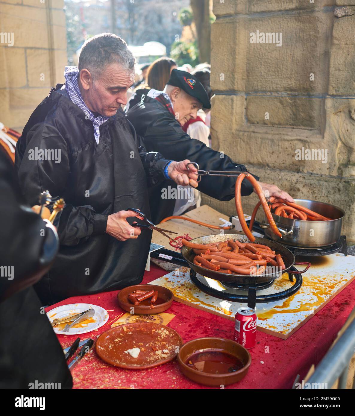 Basque farmers frying Txistorra for the typical street food of the Santo Tomas Fair on Saint Thomas's day, Talos. Stock Photo