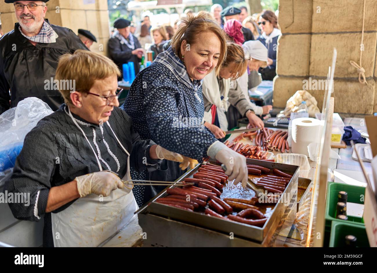 Basque farmers roasting Txistorra for the typical street food of the Santo Tomas Fair on Saint Thomas's day, Talos. Stock Photo