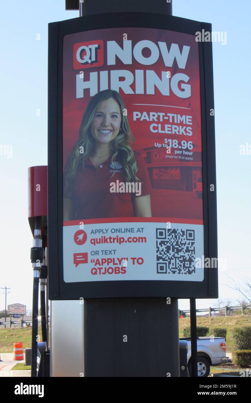 USA. 23rd Dec, 2022. A "Now Hiring" sign is displayed near gas pumps at