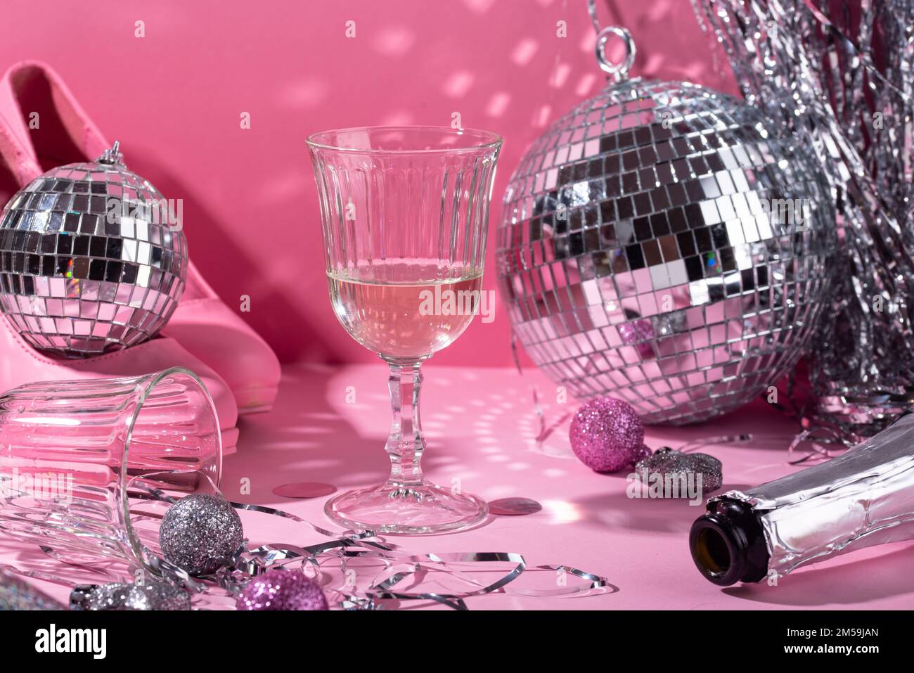 Glass of champagne with silver disco ball Stock Photo - Alamy