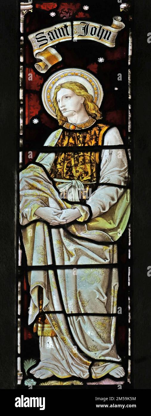 Stained glass window by Heaton Butler & Bayne depicting Saint John at the Crucifixion of Christ, St Anthony in Meneage, Cornwall Stock Photo