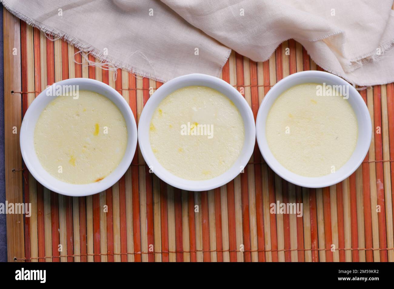 Caramel pudding in a glass jar on table  Stock Photo