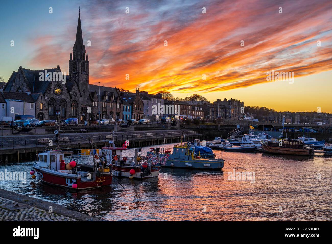 Fishing boats in Newhaven Harbour at sunset – Newhaven, Edinburgh, Scotland, UK Stock Photo