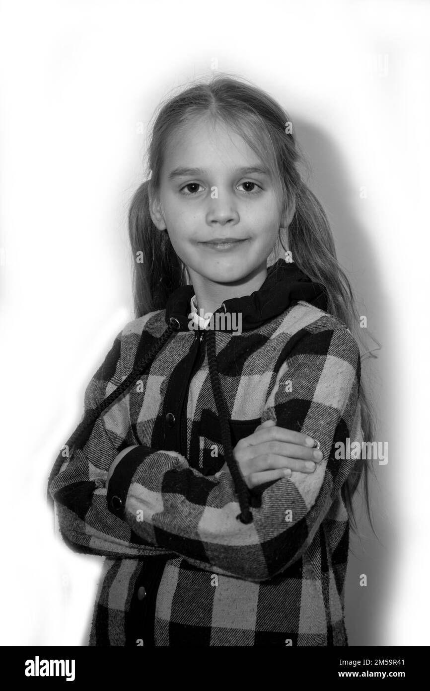 A girl in a checkered shirt on a white background Black and white photo