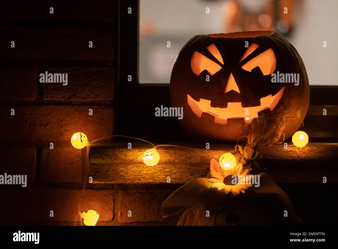 Spooky Halloween pumpkin, Jack O Lantern with pumpkins lights hanging