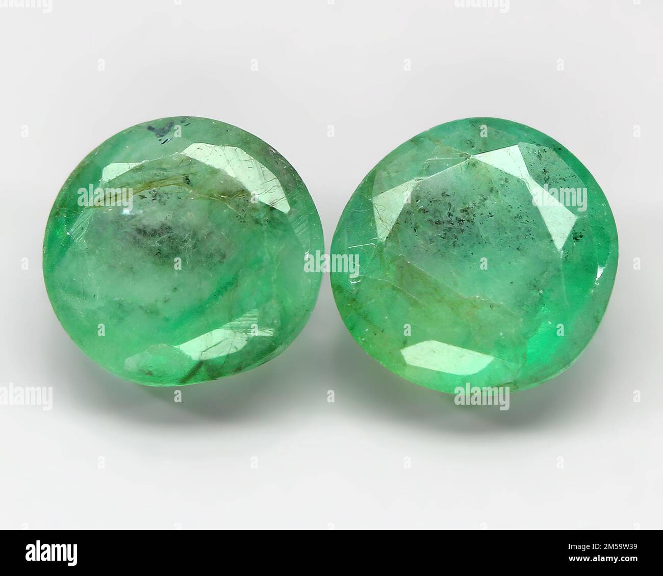 Natural gemstone green emerald on a gray background Stock Photo