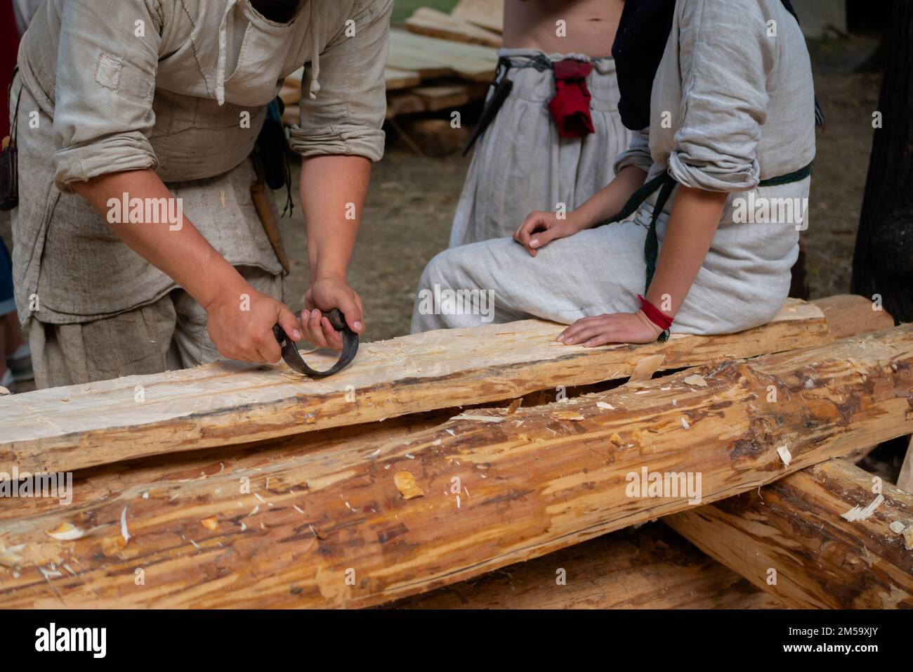 A Man Is Shaving An Wooden Log With An Drawknife Stock Photo - Download  Image Now - Drawknife, Adult, Adults Only - iStock