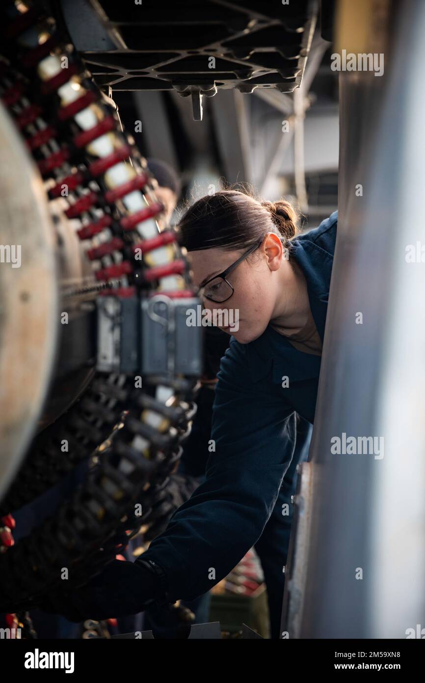 221205-N-HA192-1046  ATLANTIC OCEAN (Dec. 5, 2022) Fire Controlman 2nd Class Gena Putnam, a phalanx close-in-weapons-system (CIWS) technician, loads ammunition into the aft CIWS aboard the Wasp-class amphibious assault ship USS Bataan (LHD 5), Dec. 5, 2022. Bataan is underway participating in a Surface Warfare Advanced Tactical Training (SWATT) exercise designed to increase the lethality and tactical proficiency of the surface force across all domains. Stock Photo