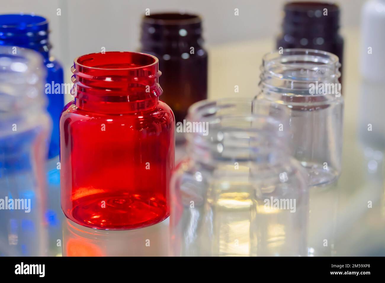 Medical empty glass bottles in showcase at pharmaceutical exhibition